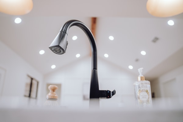 Modern black faucet on white countertop