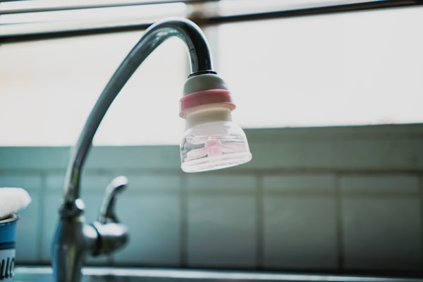 Water filtration device attached to kitchen faucet
